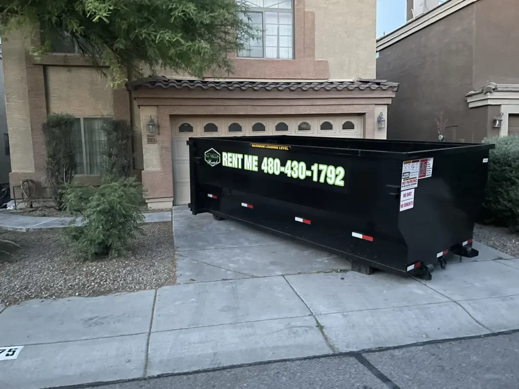Photo of a dumpster rental outside of a residential customer's house.
